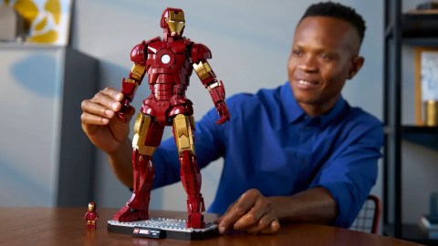 A man sitting at a table with a toy