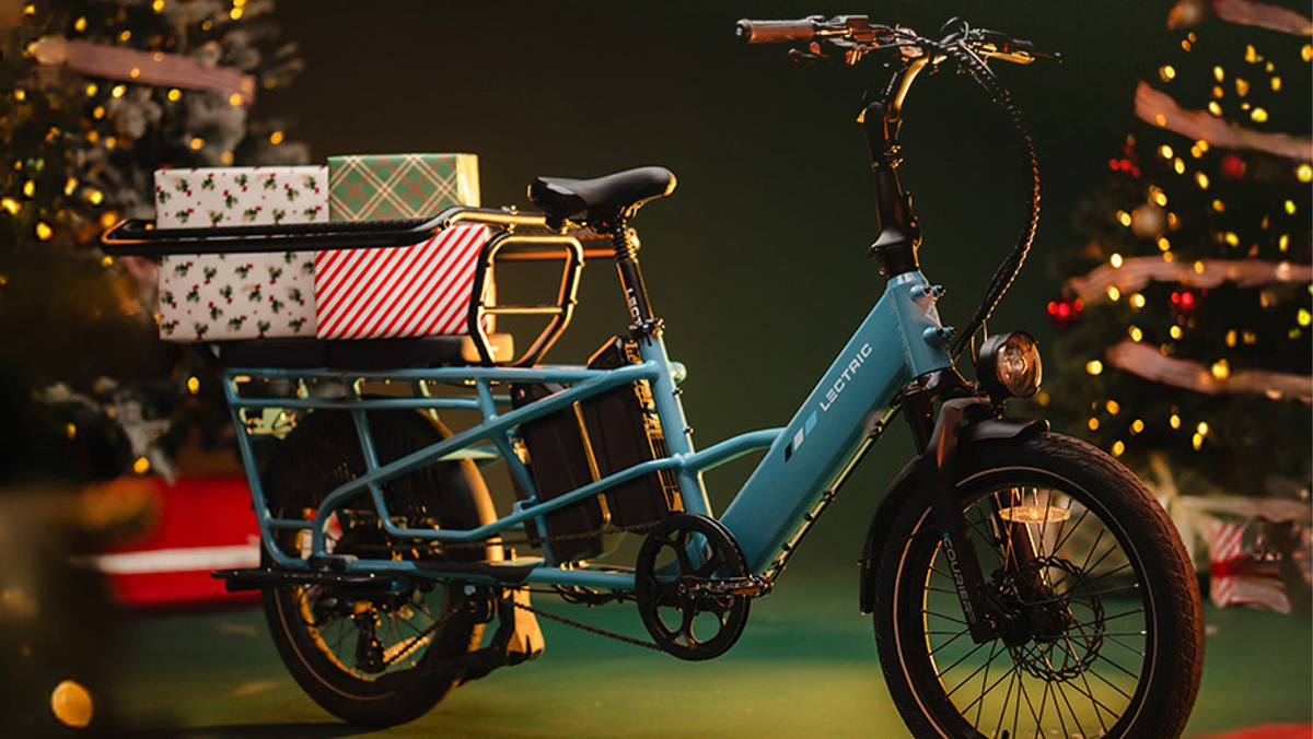 A blue electric bicycle with a basket of presents