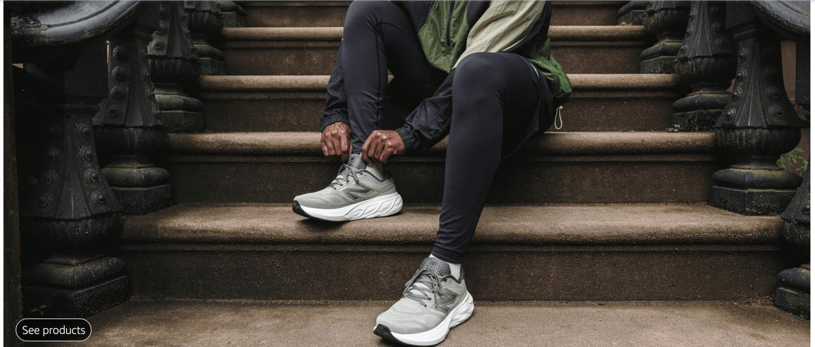 A person tying their shoes on steps