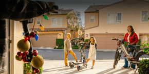 A boy and girl standing next to a scooter