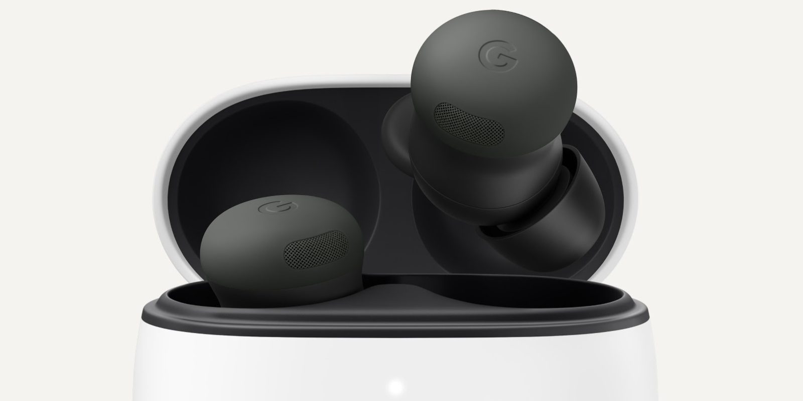 A pair of black earbuds in a white container