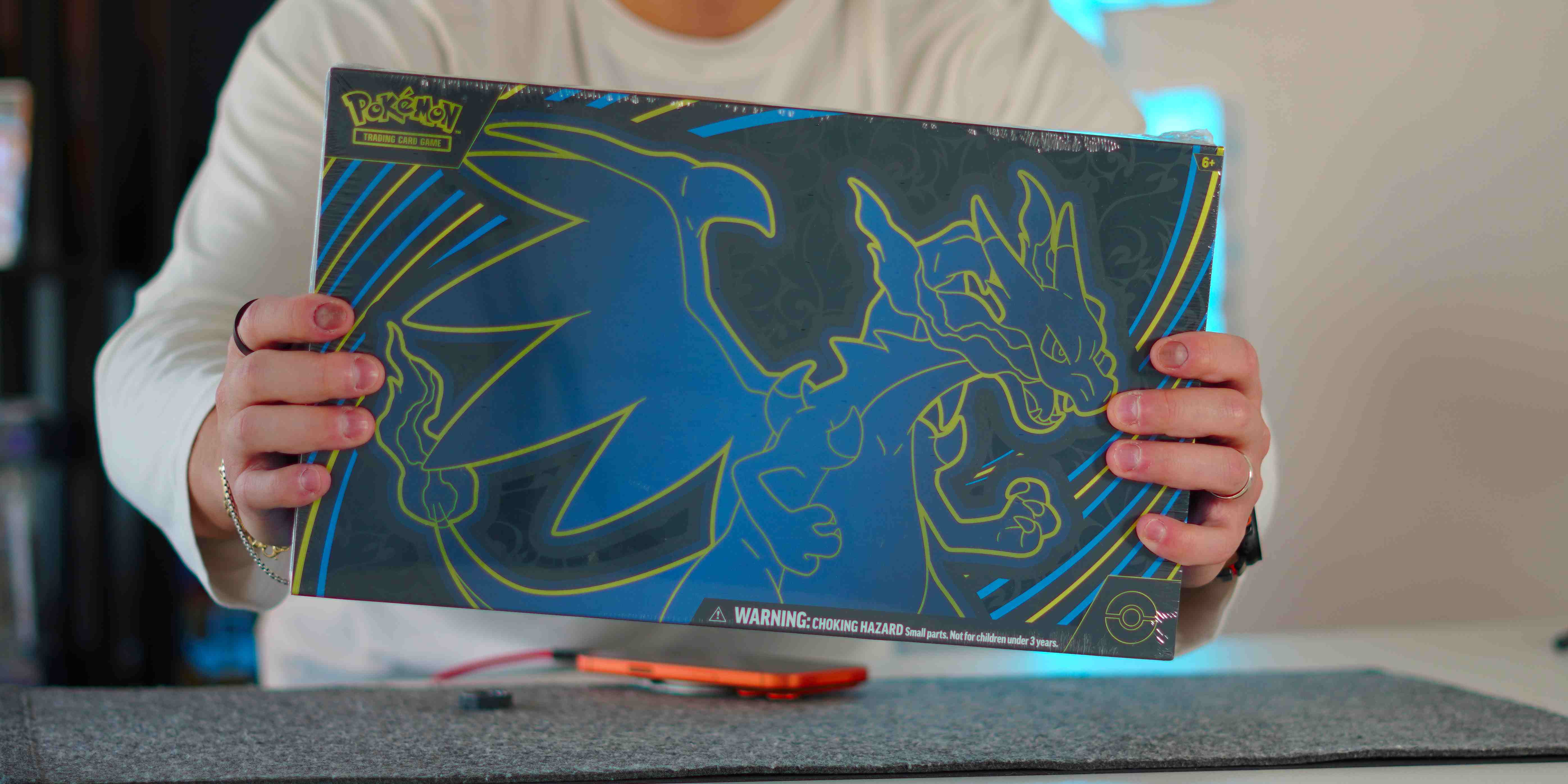 A person holding a blue and yellow board