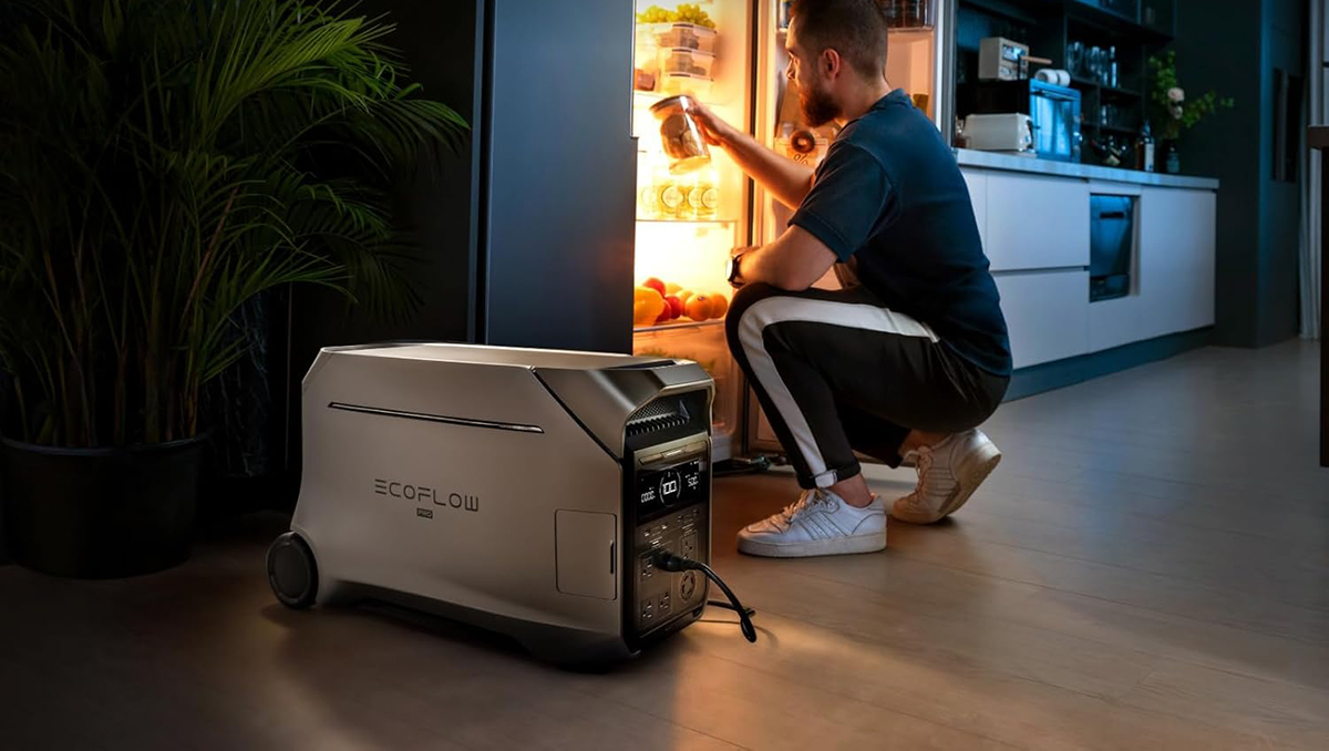 A man kneeling in front of a refrigerator