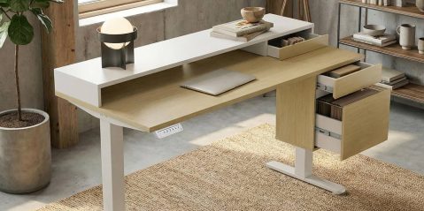 A desk with a laptop and a shelf