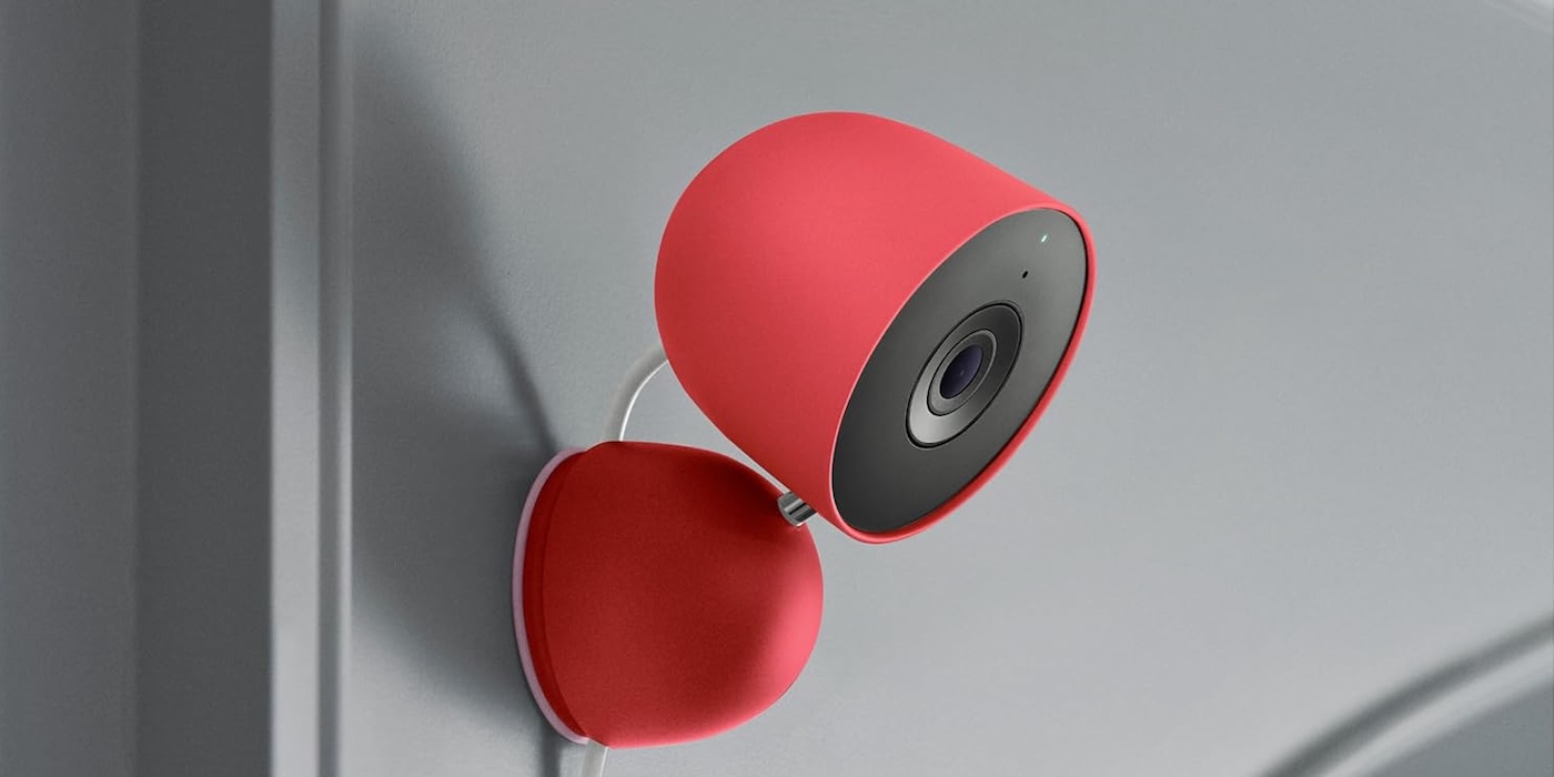 A red and black camera on a white wall