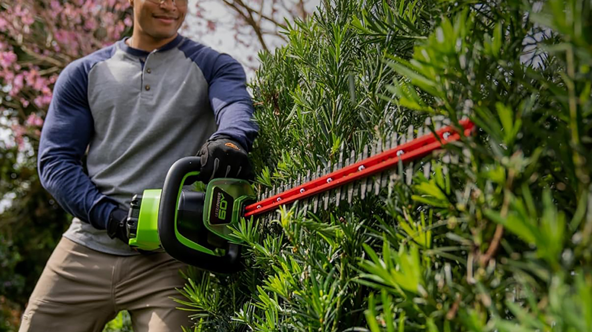 A man using a hedge trimmer