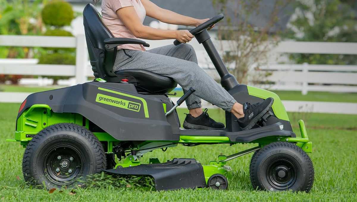 A woman driving a lawn mower
