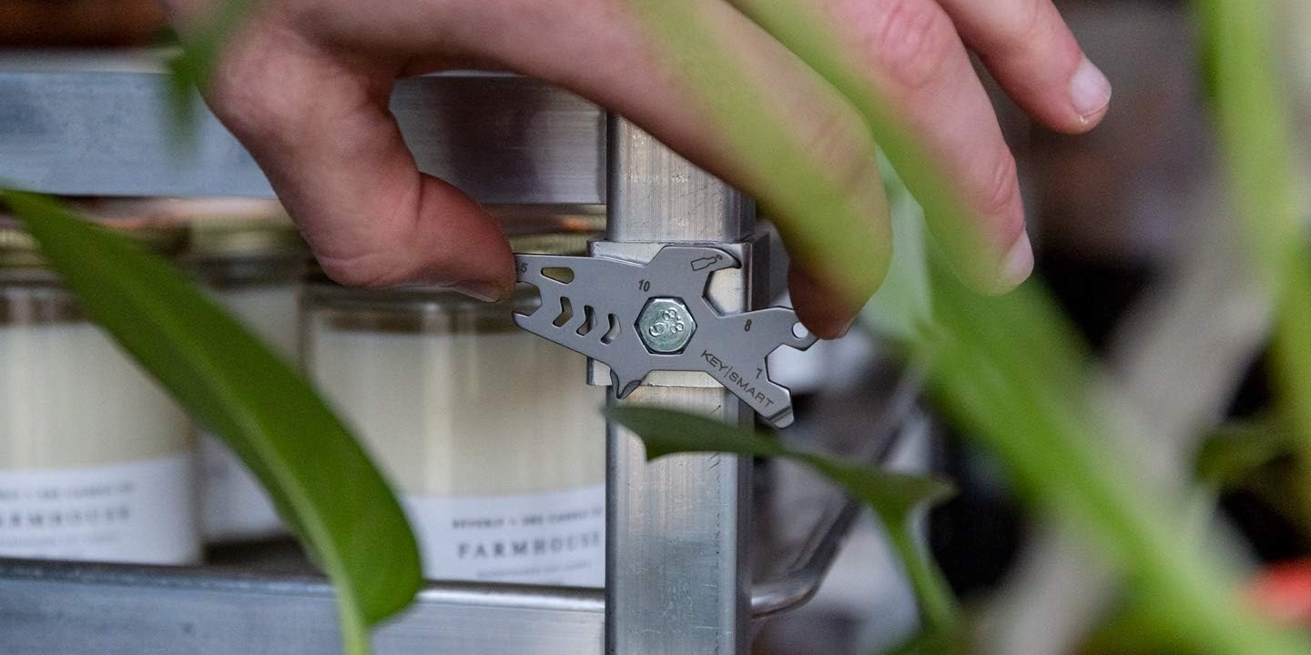 A hand holding a key cutter