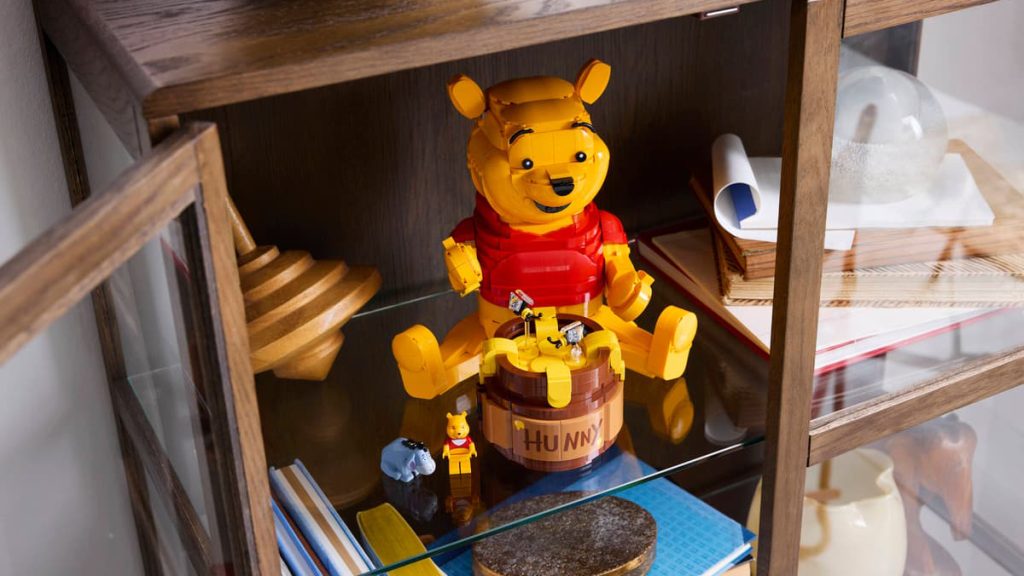 A winnie the pooh figurines on a shelf