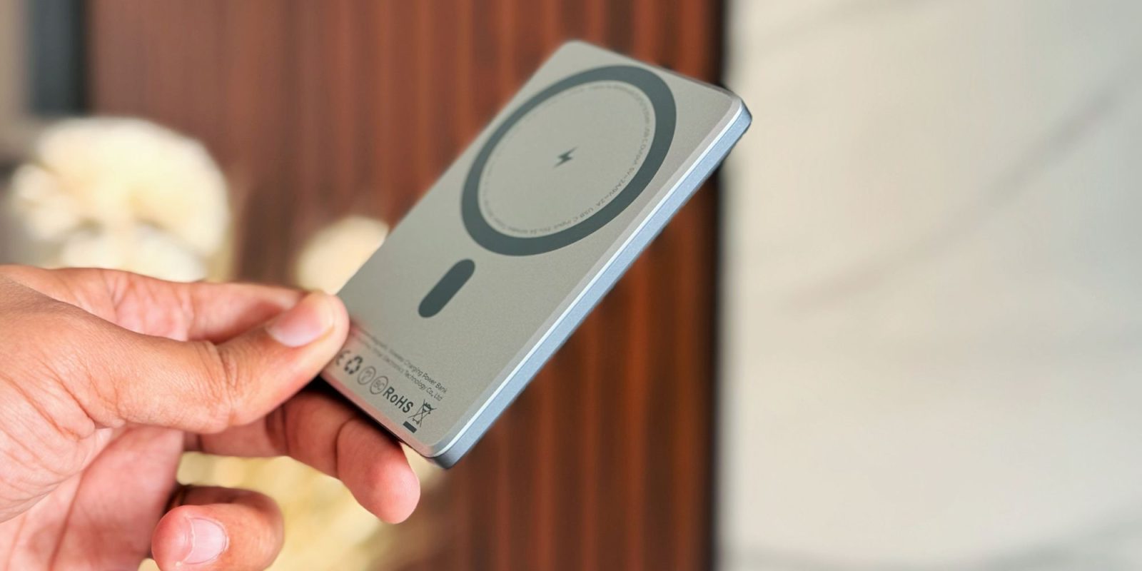 Image showing a person holding LISEN's 5K MagSafe power bank.