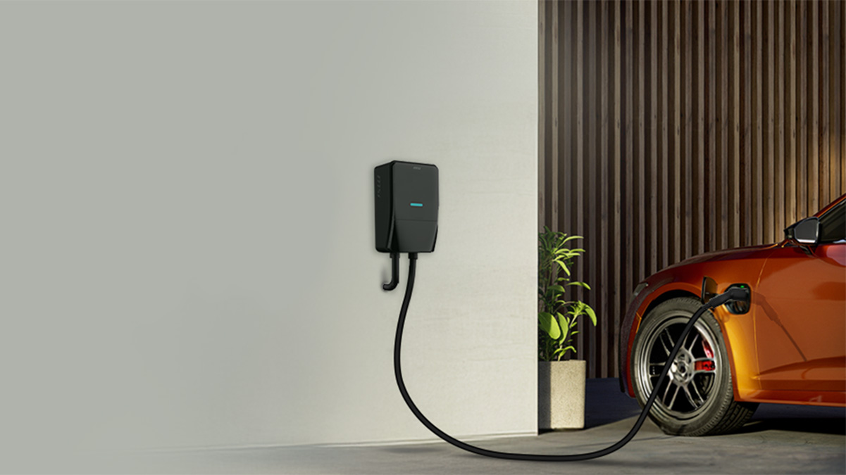 A black electrical box with a cable attached to a wall