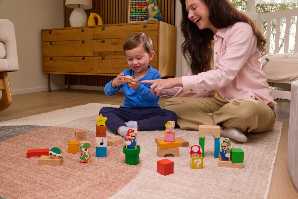 A woman and a child playing with blocks