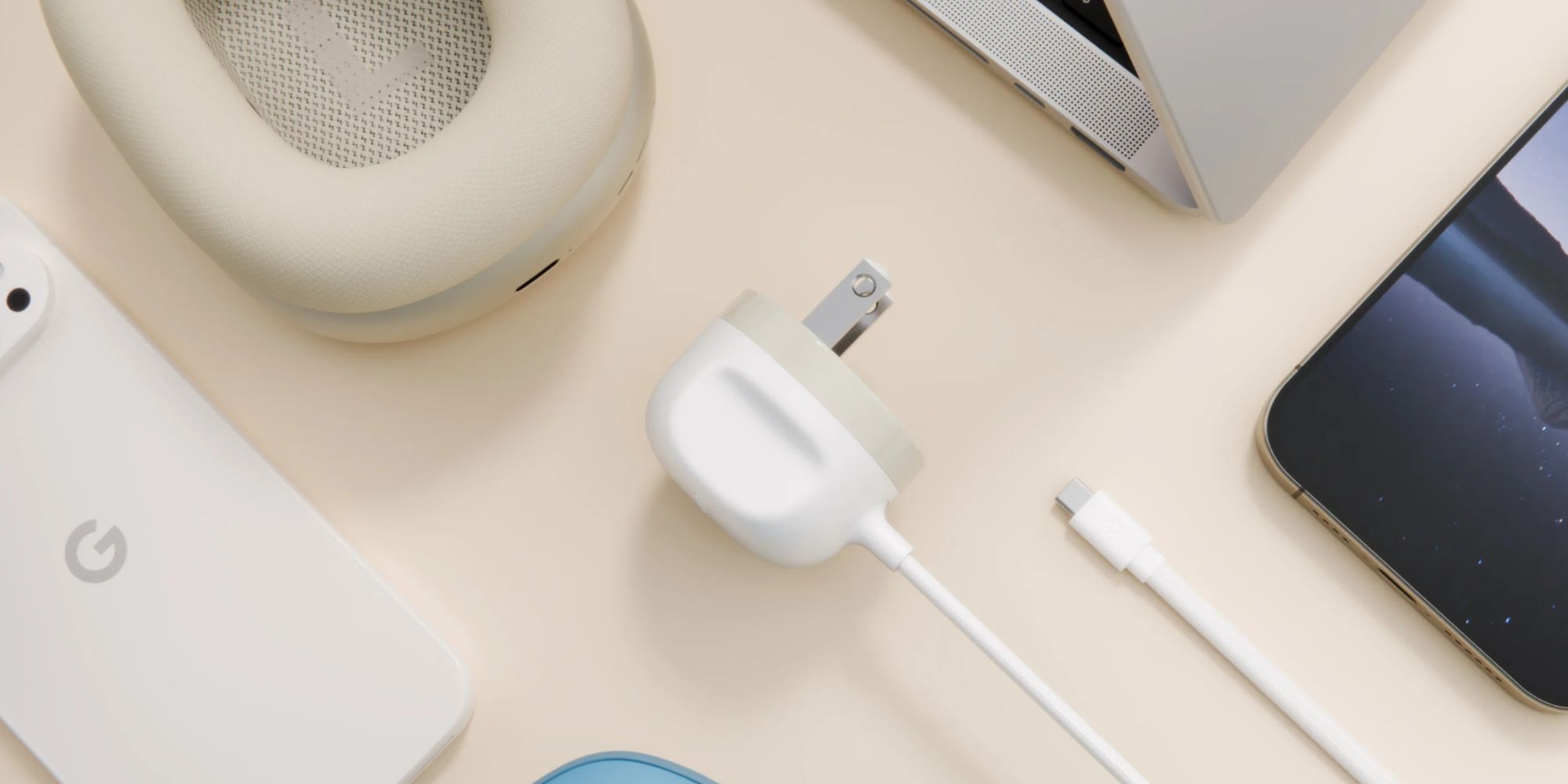 A white charger plugged into a white laptop