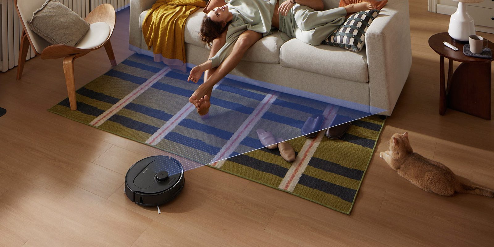 A woman lying on a couch with her legs on the floor