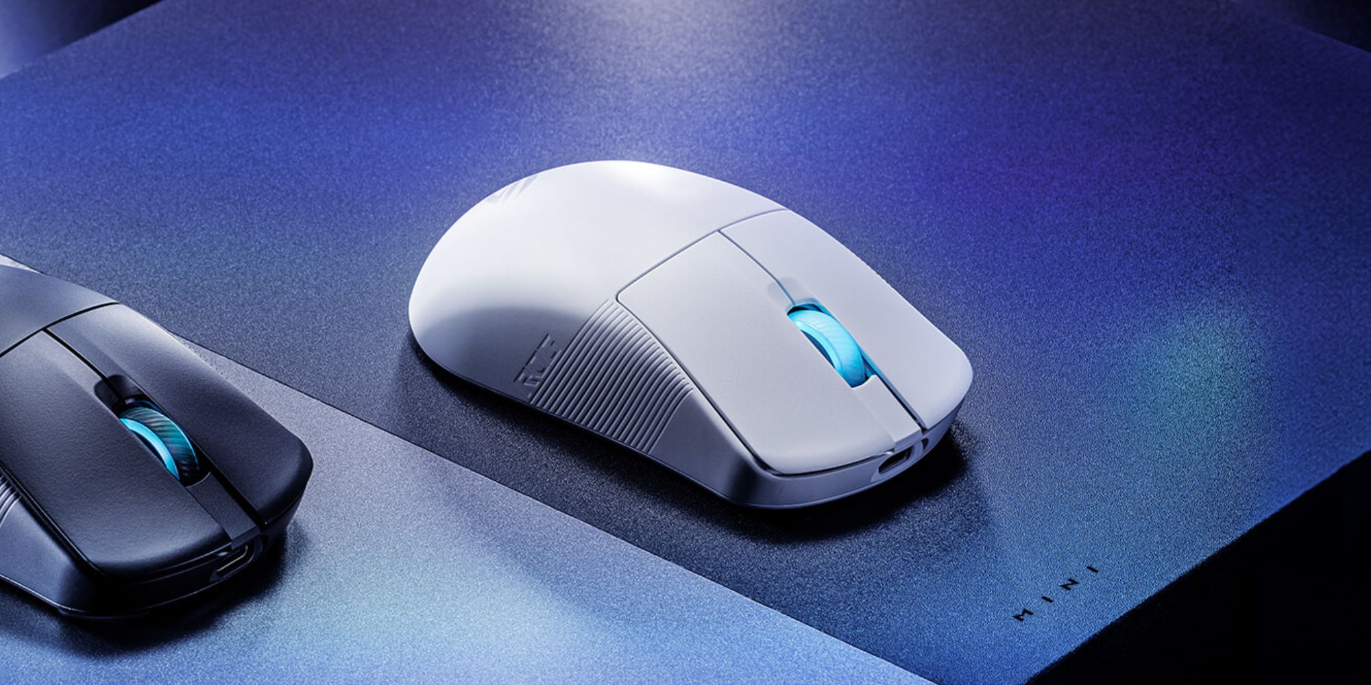 A white computer mouse on a blue and black surface