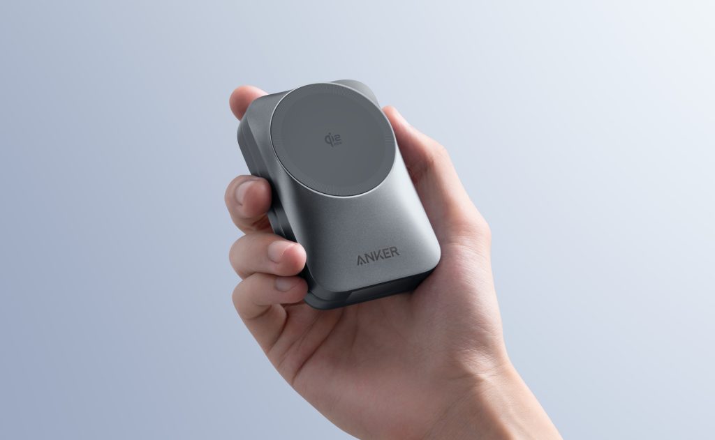 A hand holding a device