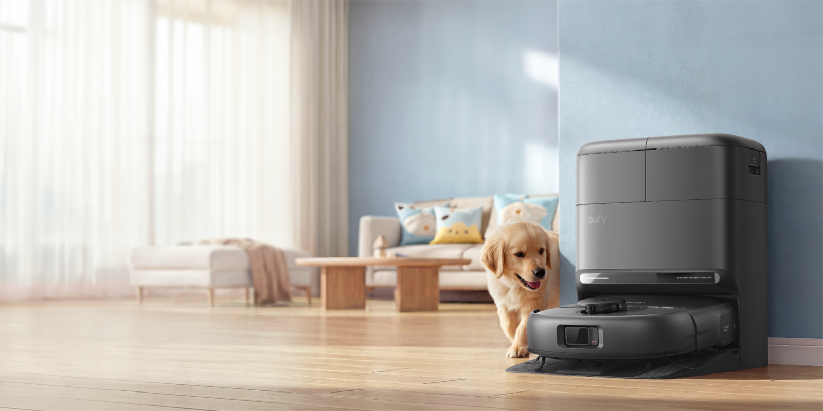 A dog standing next to a vacuum cleaner