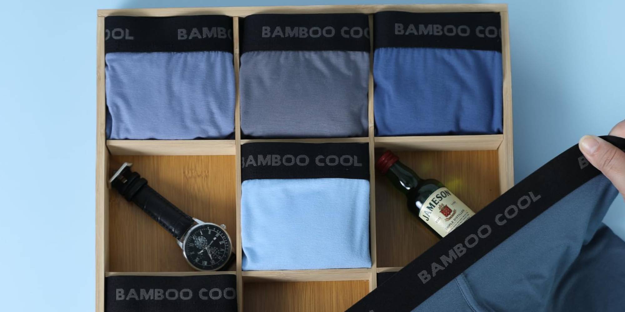 A drawer with underwear and a bottle of alcohol