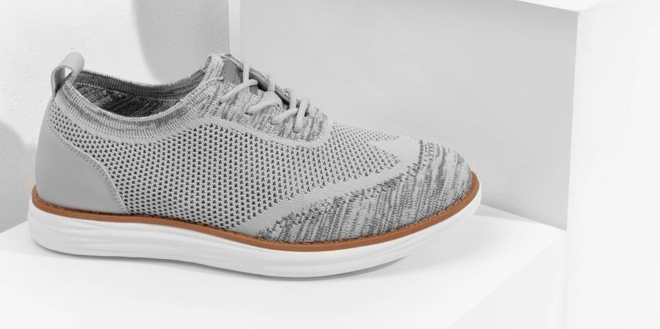 A grey shoe on a white shelf