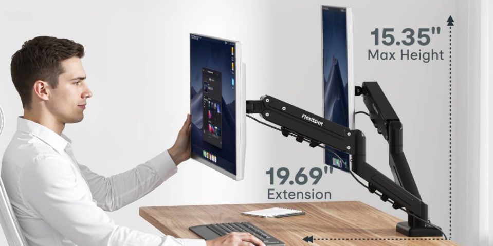 A person holding a computer monitor