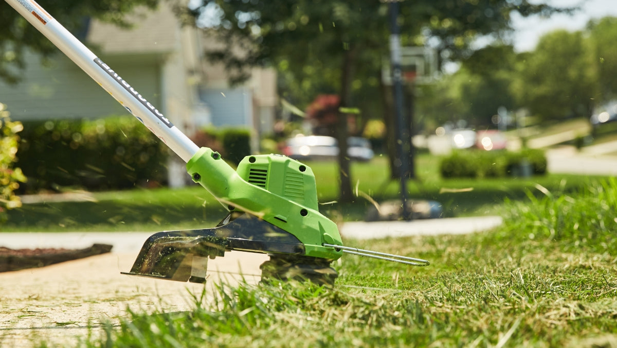 A green lawn mower on grass