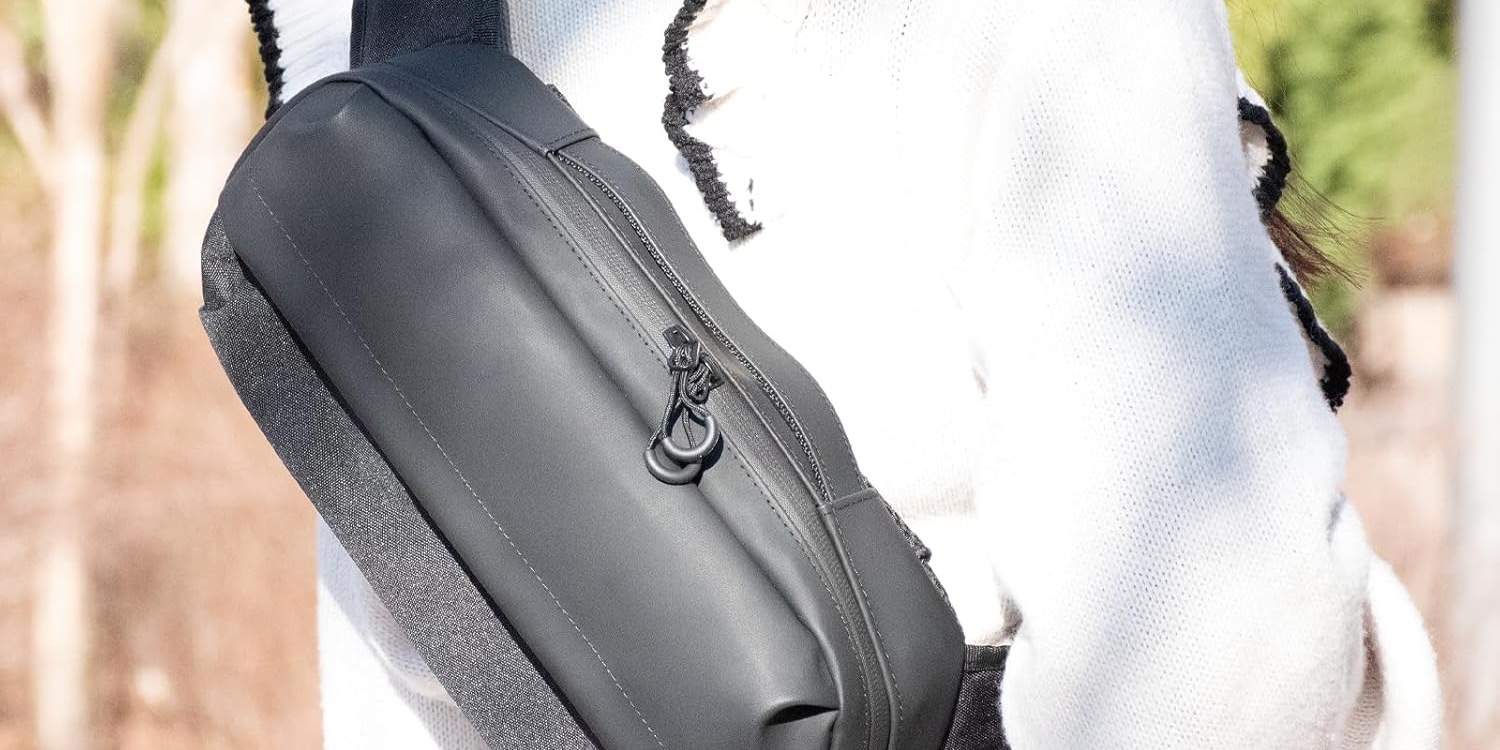 A black bag on a white cloth