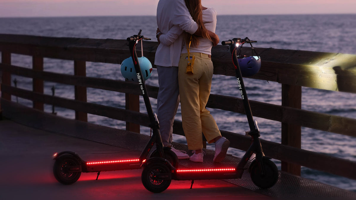 Two people hugging on a scooter