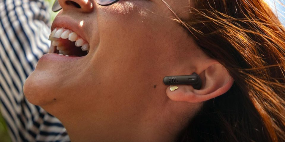A woman wearing a wireless earpiece