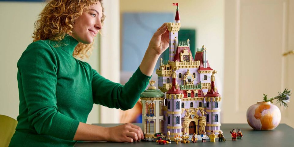 A woman holding a toy castle