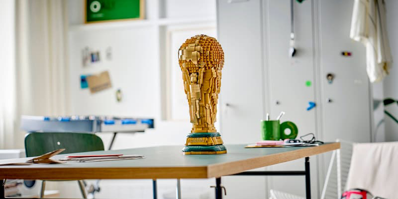 A statue of a man made of blocks on a table