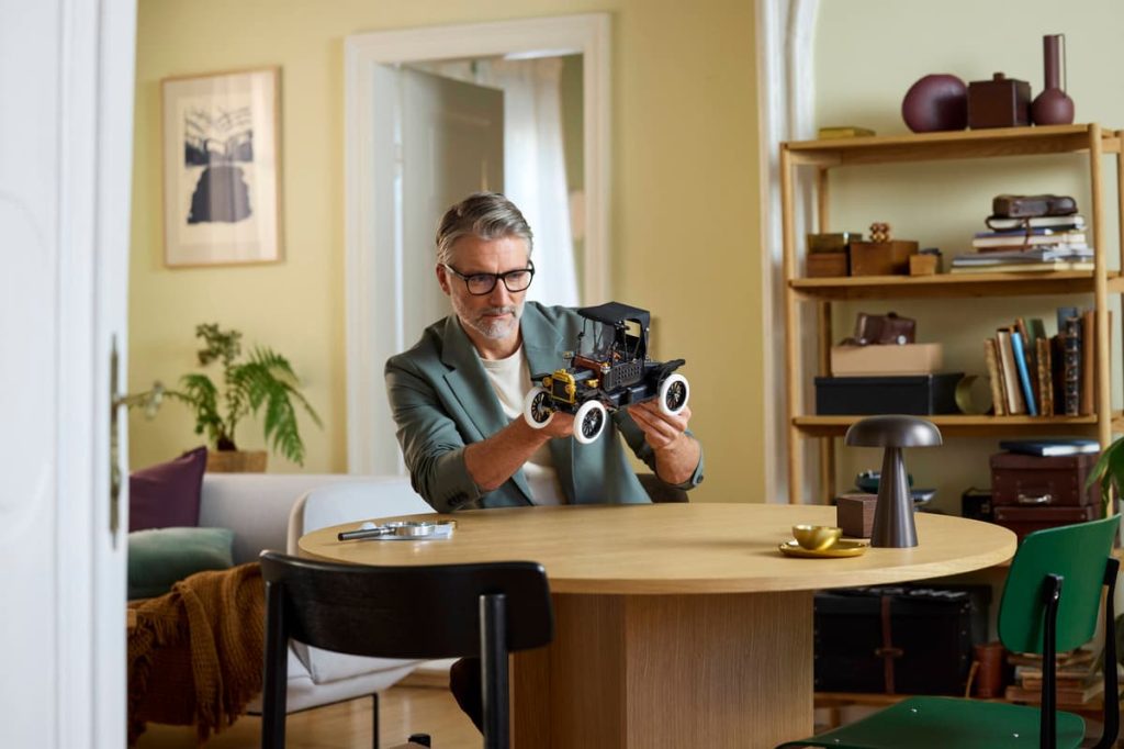 A man holding a LEGO Icons Model T