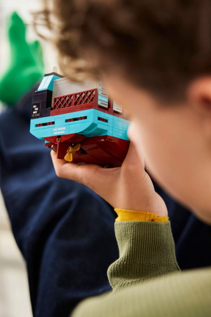 A child holding a toy boat
