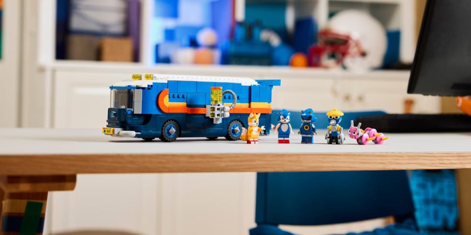A group of toy figures next to a toy bus