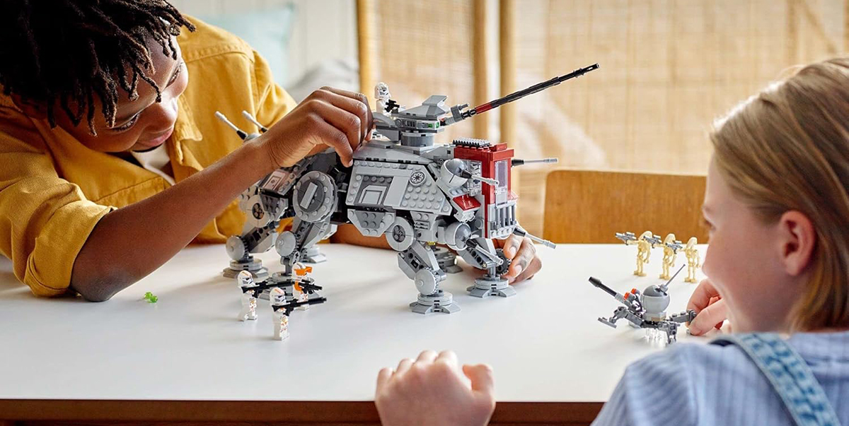 A person playing with a toy robot