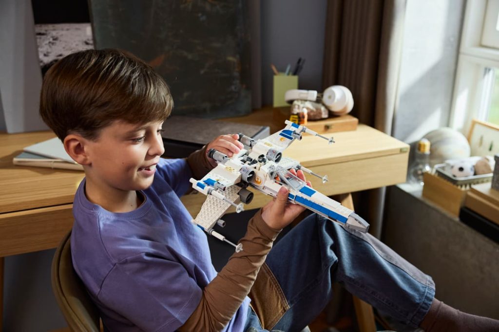 A boy holding a toy plane