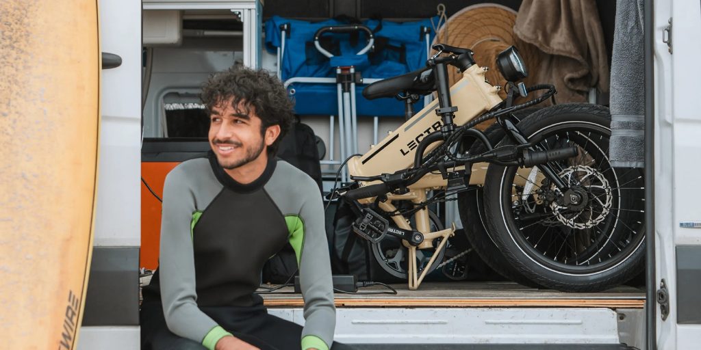 A man sitting in front of a bicycle