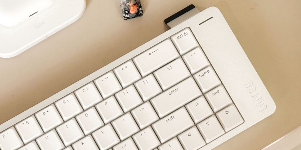 A white keyboard on a desk