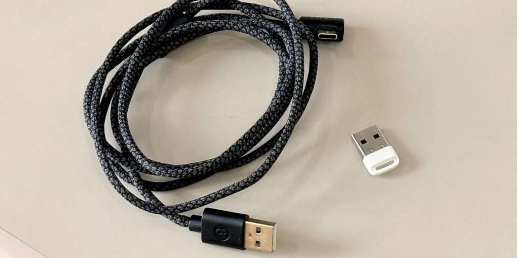 A black cord with a white plug next to it
