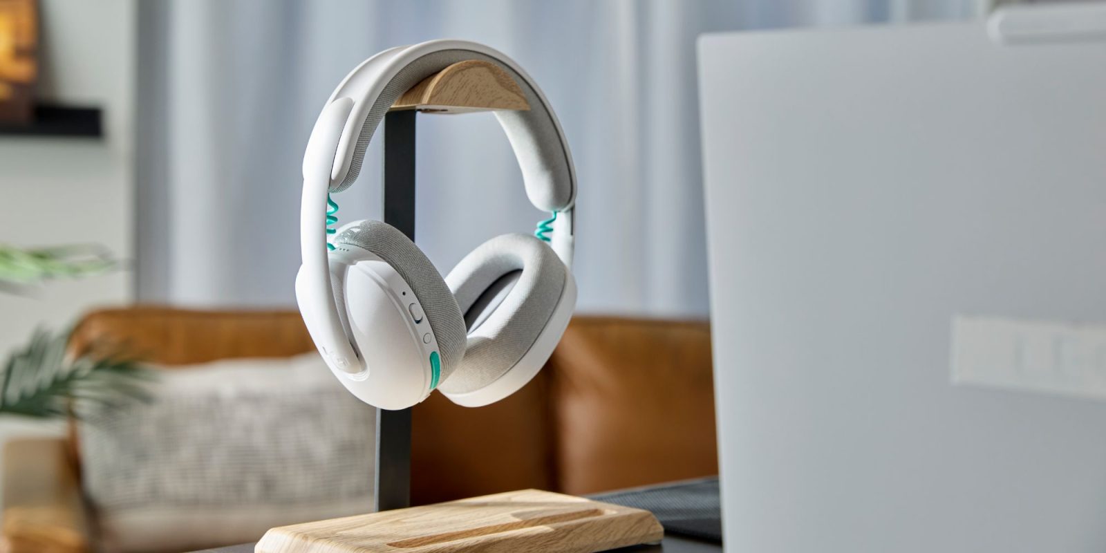 A pair of white headphones on a stand