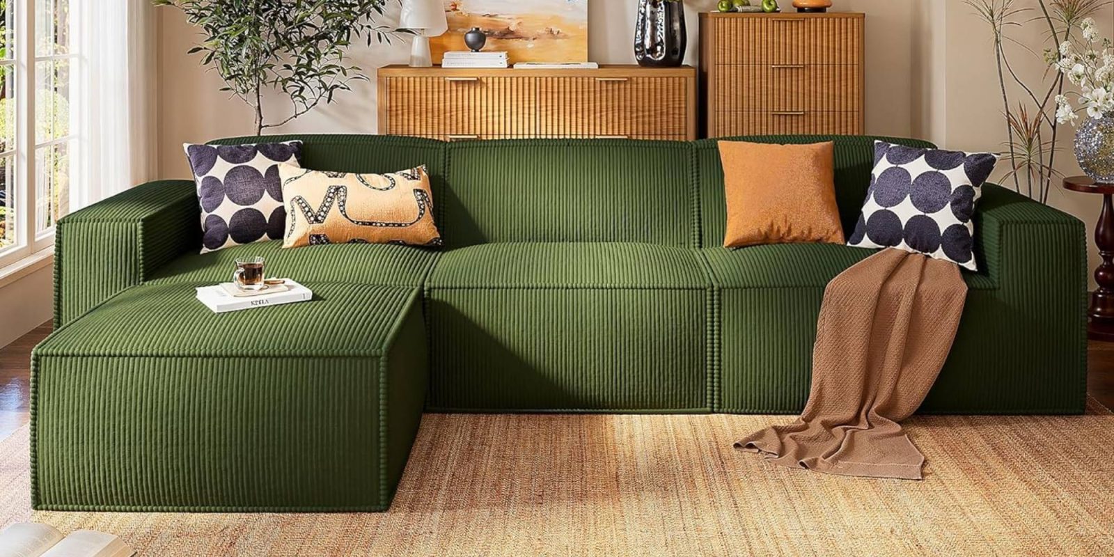 A green couch with pillows in a living room