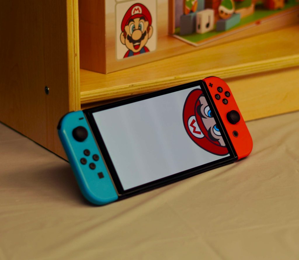 A video game console with a cartoon character on the screen