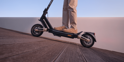 A person's feet on a scooter