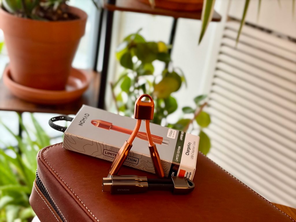 A box and a couple of cables on a suitcase