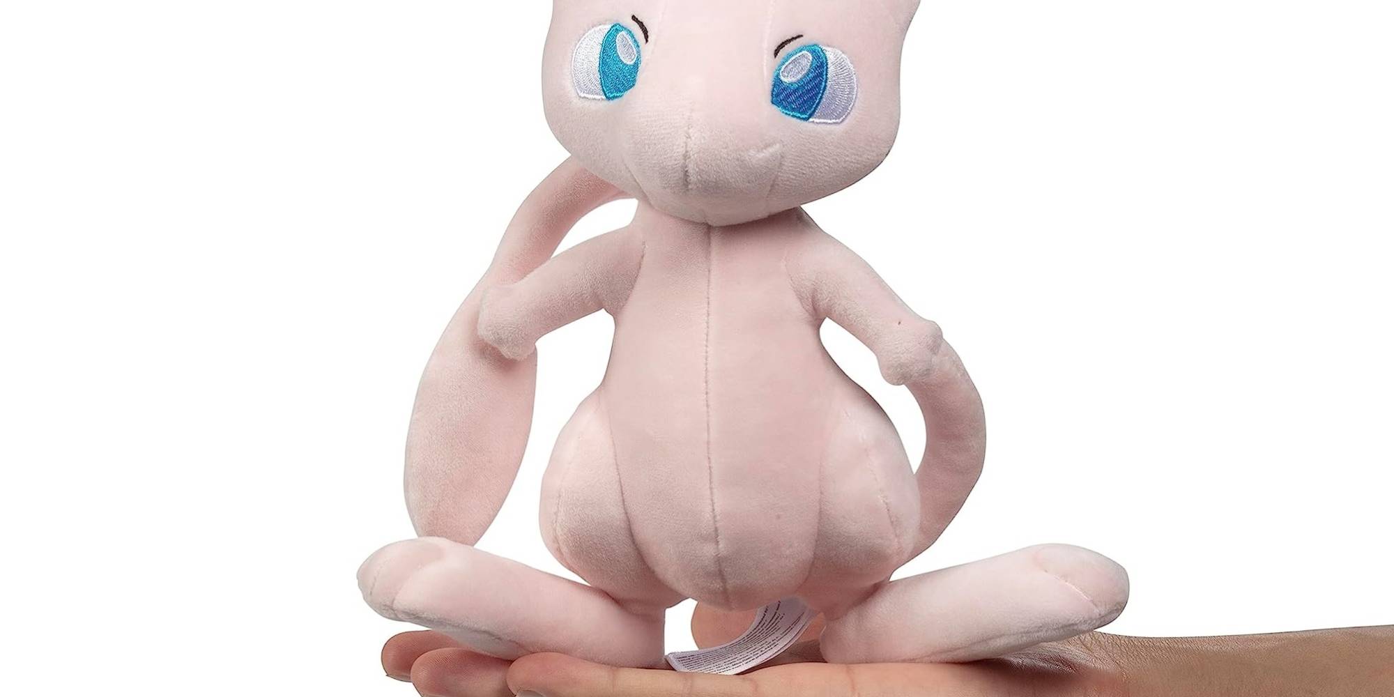 A hand holding a stuffed animal