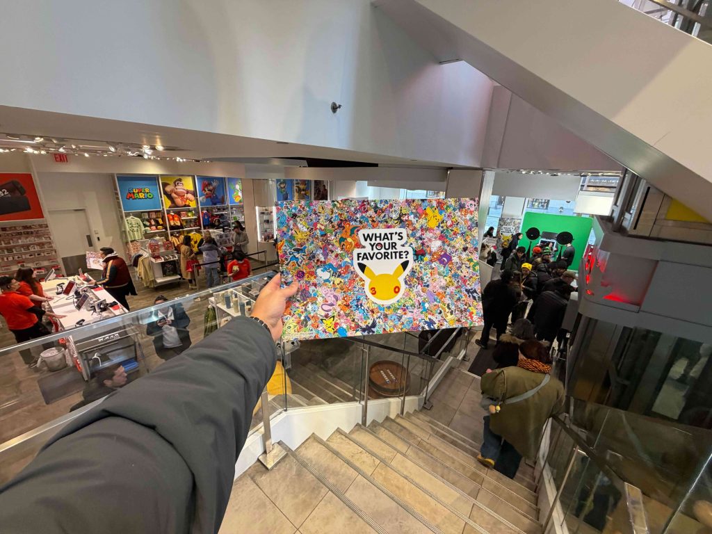 A hand holding a poster with a cartoon character on it