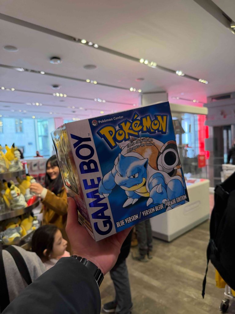 A hand holding a box with a cartoon character on it