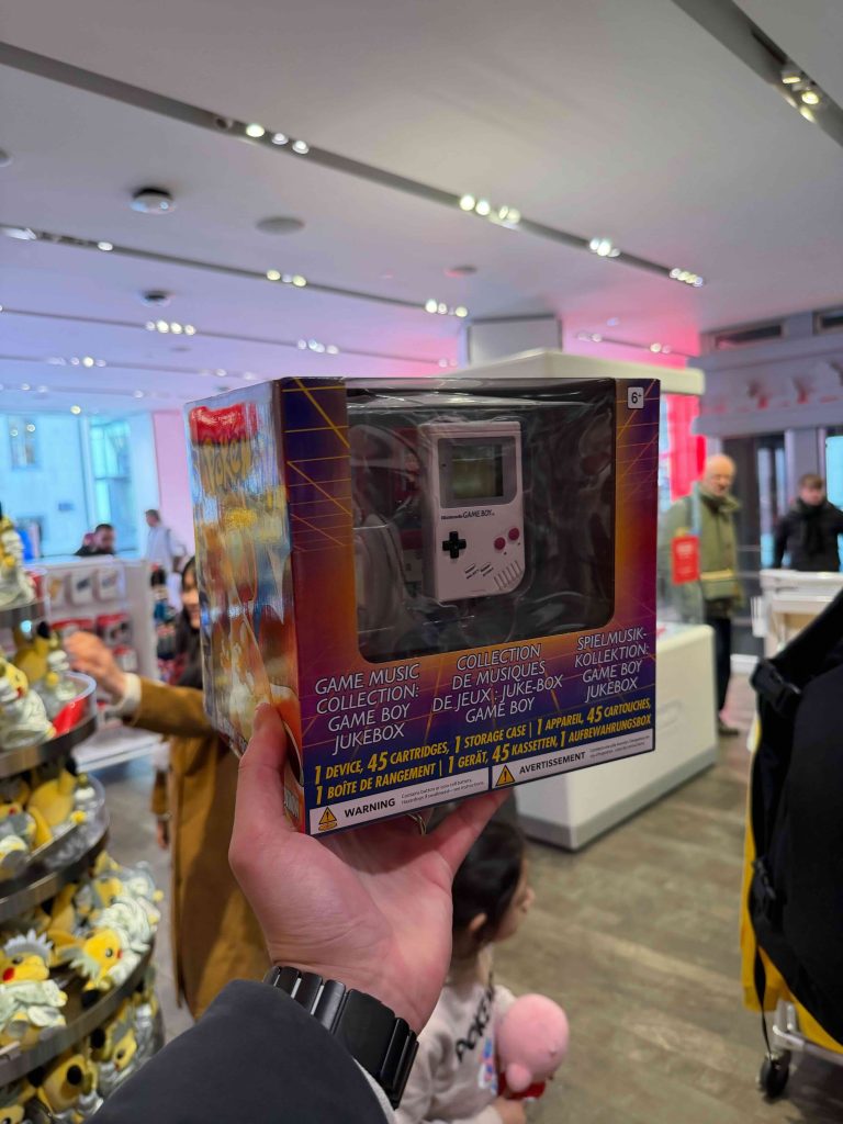 A hand holding a box with a video game controller inside