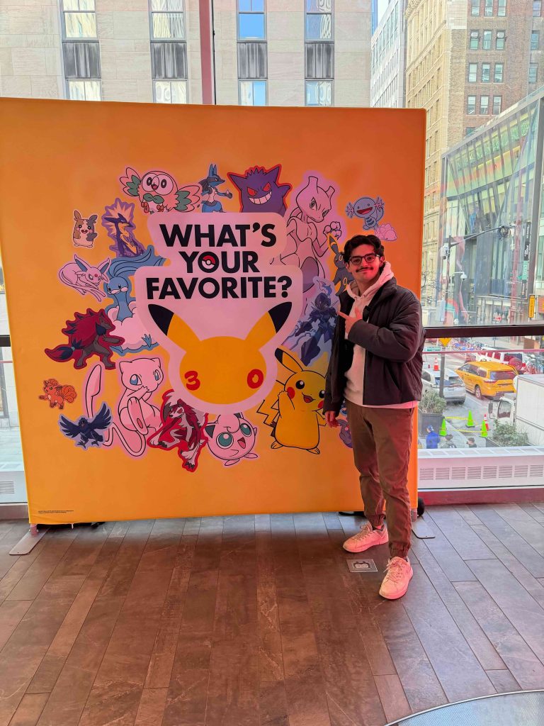 A man standing next to a large yellow sign