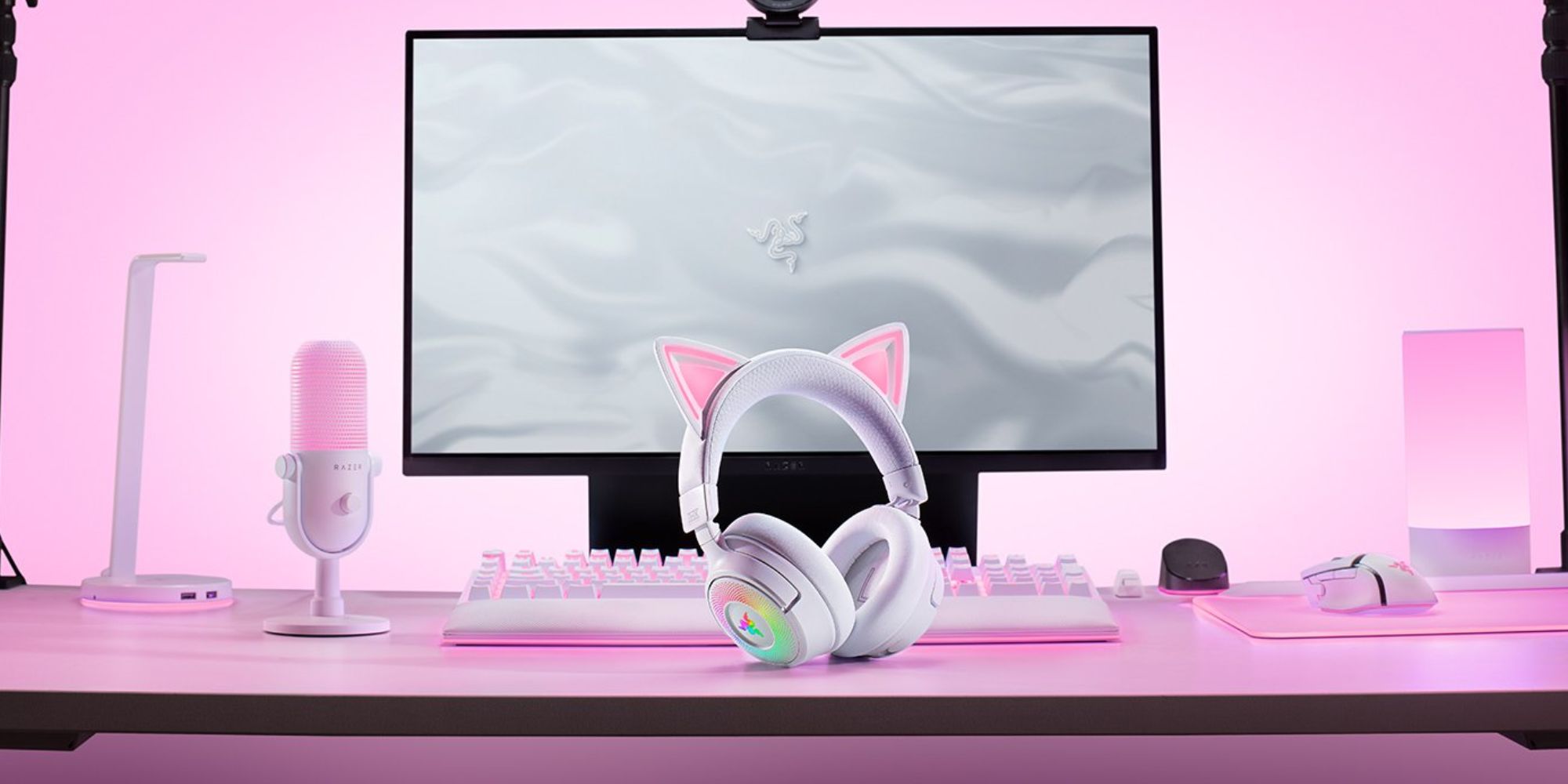 A white headphones with cat ears on a pink desk