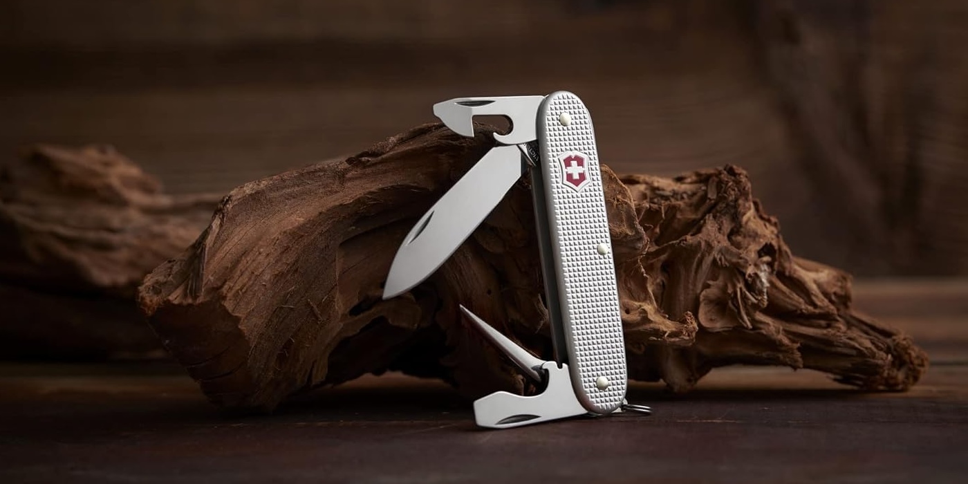 A swiss army knife on a wood surface